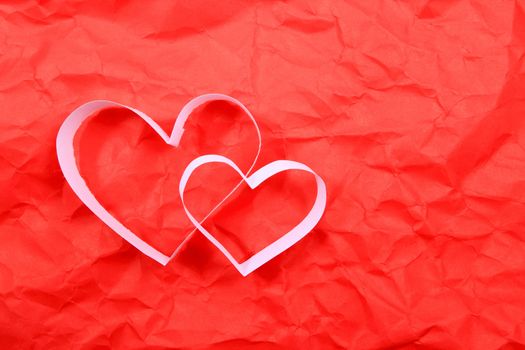 Paper hearts on red background