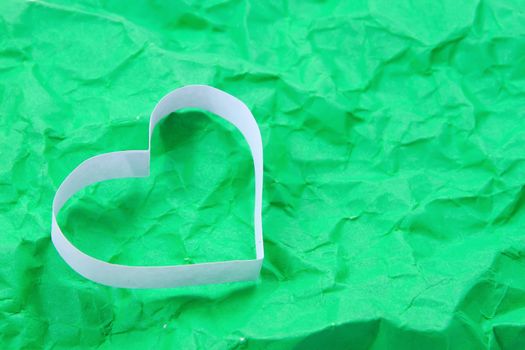 Paper hearts on green background