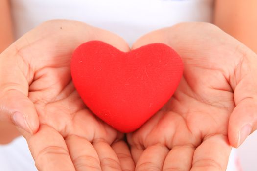 Female hands with red heart