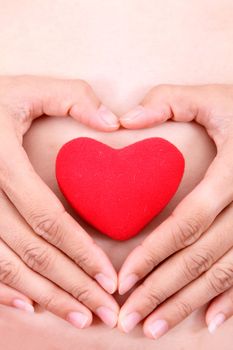 Female hands with red heart