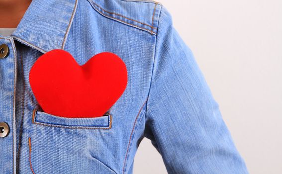 Red heart sticking out of blue jeans back pocket