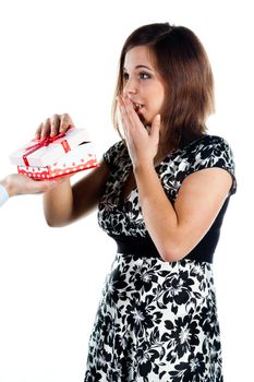 Young handsome man giving a young beautiful girl, a red box with a red bow on top