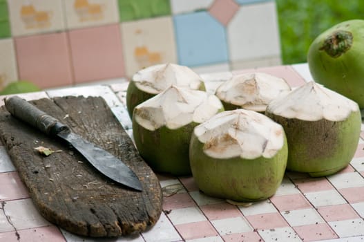 Coconut with knife on table