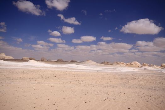 Wind and sand modeled rock sculptures in white desert