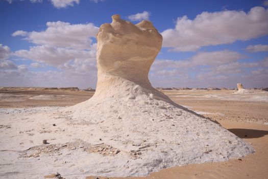 Wind and sand modeled rock sculptures in white desert