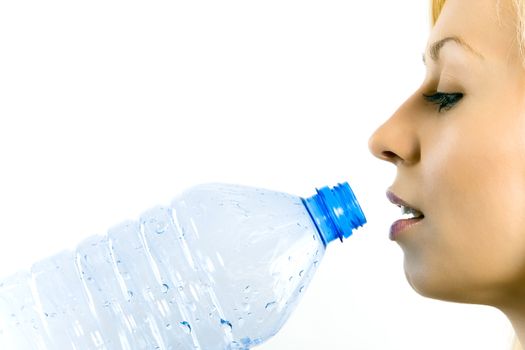 Young beautiful woman drinking mineral water isolated on white.