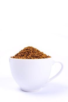 Coffee granules in a white cup isolated.