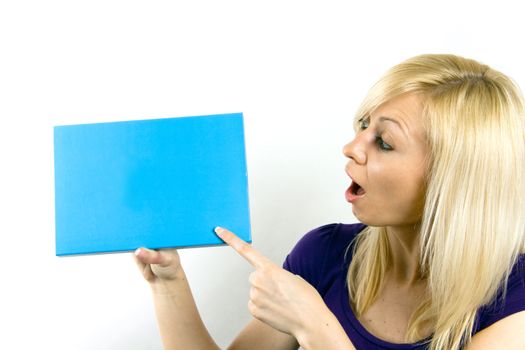 Portrait of a beautiful  surprised woman holding a blank blue notecard.