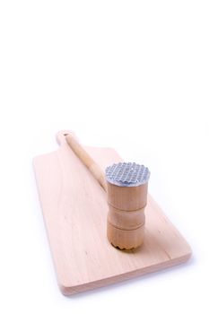 Wooden meat hammer on kitchen board isolated on white background.