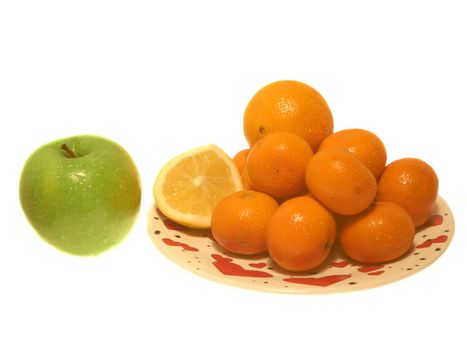 apple with lemon and tangerine on plate ower wehite. isolated.