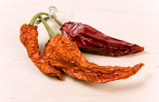 Dried-up red paprika on kitchen board