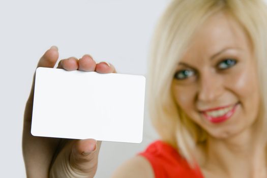 Portrait of a beautiful business woman holding a blank white notecard (business card)