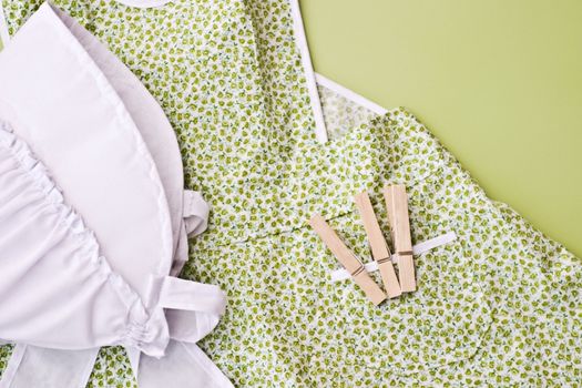 Amish child's apron and bonnet with clothes pins.