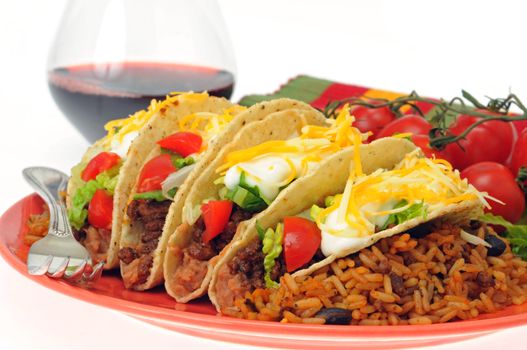 Meal of delicious tacos with mexican style rice.
