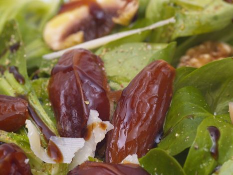 lamb's lettuce with dates, walnuts, champignos and parmesan cheese