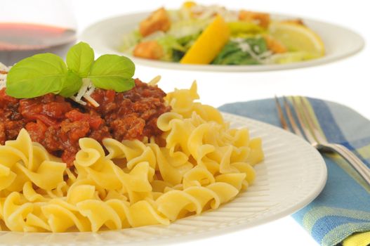 Delicious pasta with a rich meat sauce and salad.