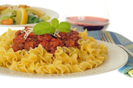 Pasta with a tomato basil sauce and salad.