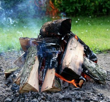 Close-up of bonfire with smoke, fireplace.