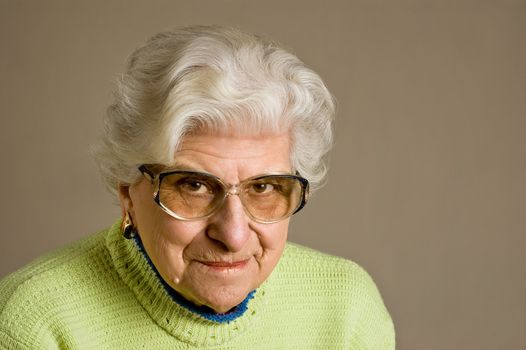 Senior lady portrait, smiling, glasses, with copy space.