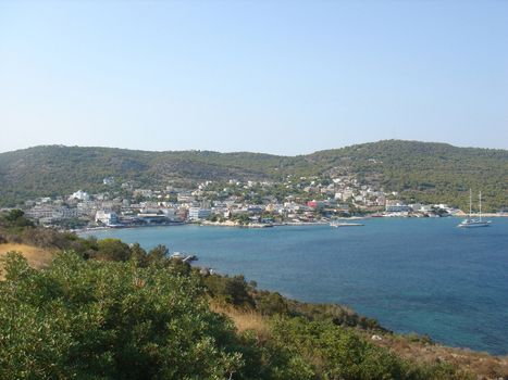 Sea bay with houses and a yacht in Aghia Marina              