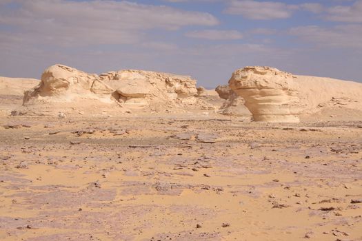 Wind and sand modeled rock sculptures in white desert