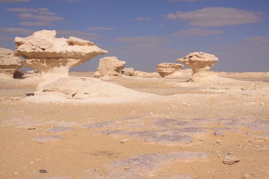 Wind and sand modeled rock sculptures in white desert