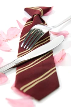 knife and fork with a school tie as concept for loving school dinners