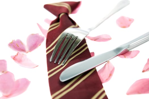 knife and fork with a school tie as concept for loving school dinners