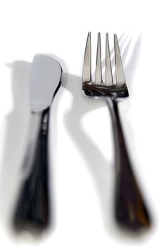 knife and fork with shadows isolated against a white background