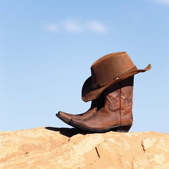 brown cowboy hat and boots outdoor