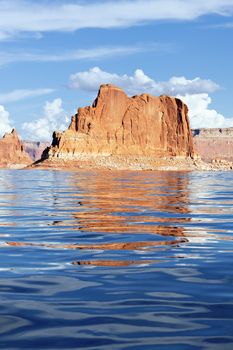 orange cliffs reflected in the smooth water of the lake Powell