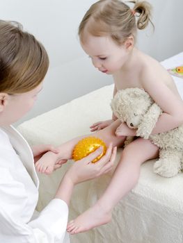 Therapist makes a child massage 