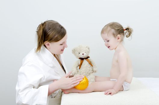 Therapist makes a child massage 