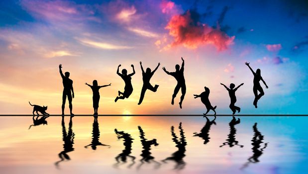 Happy group of friends, family with dog and cat jumping together at sunset, water reflection