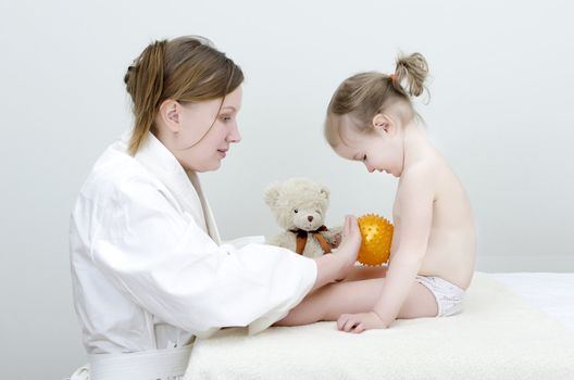 Therapist makes a child massage 
