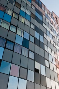 Office building striped wall with square windows and colored blocks