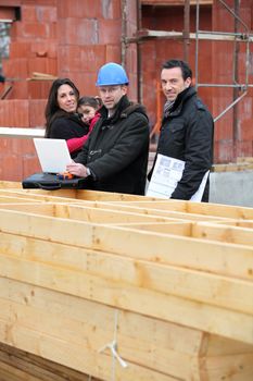Architect with young family at construction site
