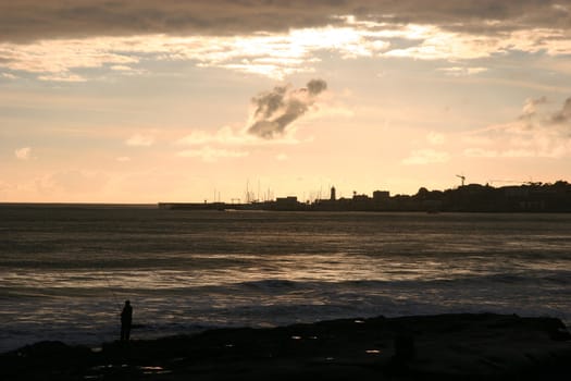 Fishing on a beautiful sunset in Estoril, Portugal