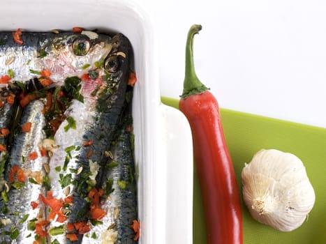 Closeup of sardines with chili, garlic and parsley