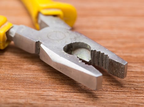 pliers closeup on a wooden table