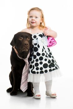 Cute little girl hugging black retriever