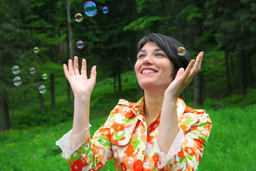 Young woman full of joy because of bubbles