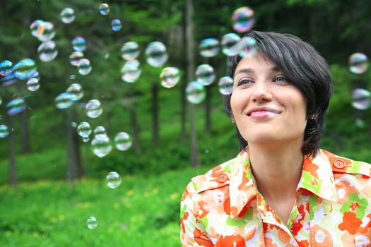 Young woman full of joy because of bubbles