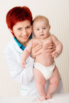 Smiling doctor with beautiful baby