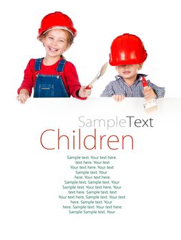 Pretty little girl and boy in halmet holding white banner with sample text