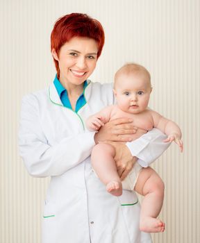 Smiling doctor with beautiful baby girl