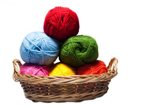 isolated colorful acrylic fibers in the basket on white background