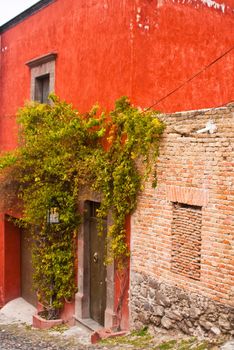 Red adobe house with brick walls in San Miguel de Allende, Mexico