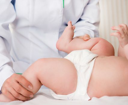 woman massaging little baby girl