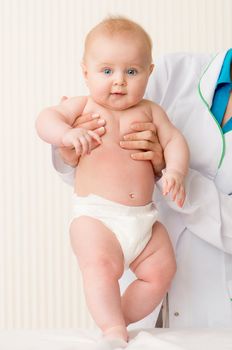 Smiling doctor with beautiful baby